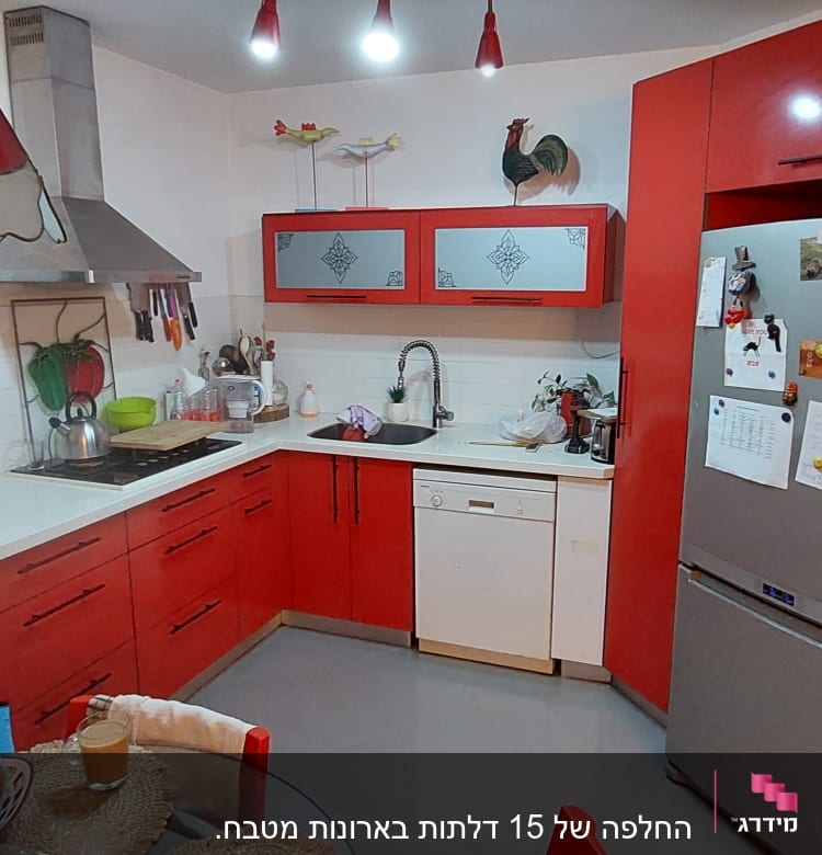 מטבח עם ארונות אדומים וכלי עבודה על השיש